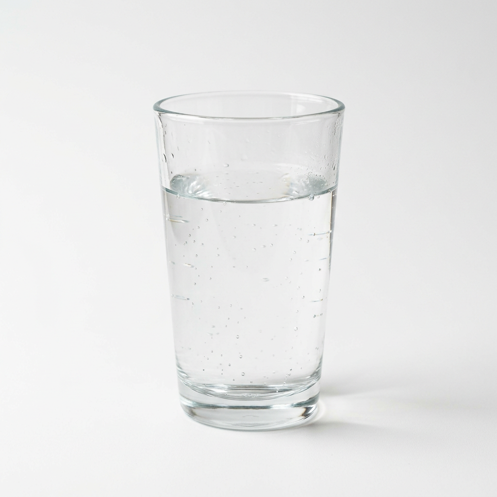 Clear glass filled with sparkling water and bubbles