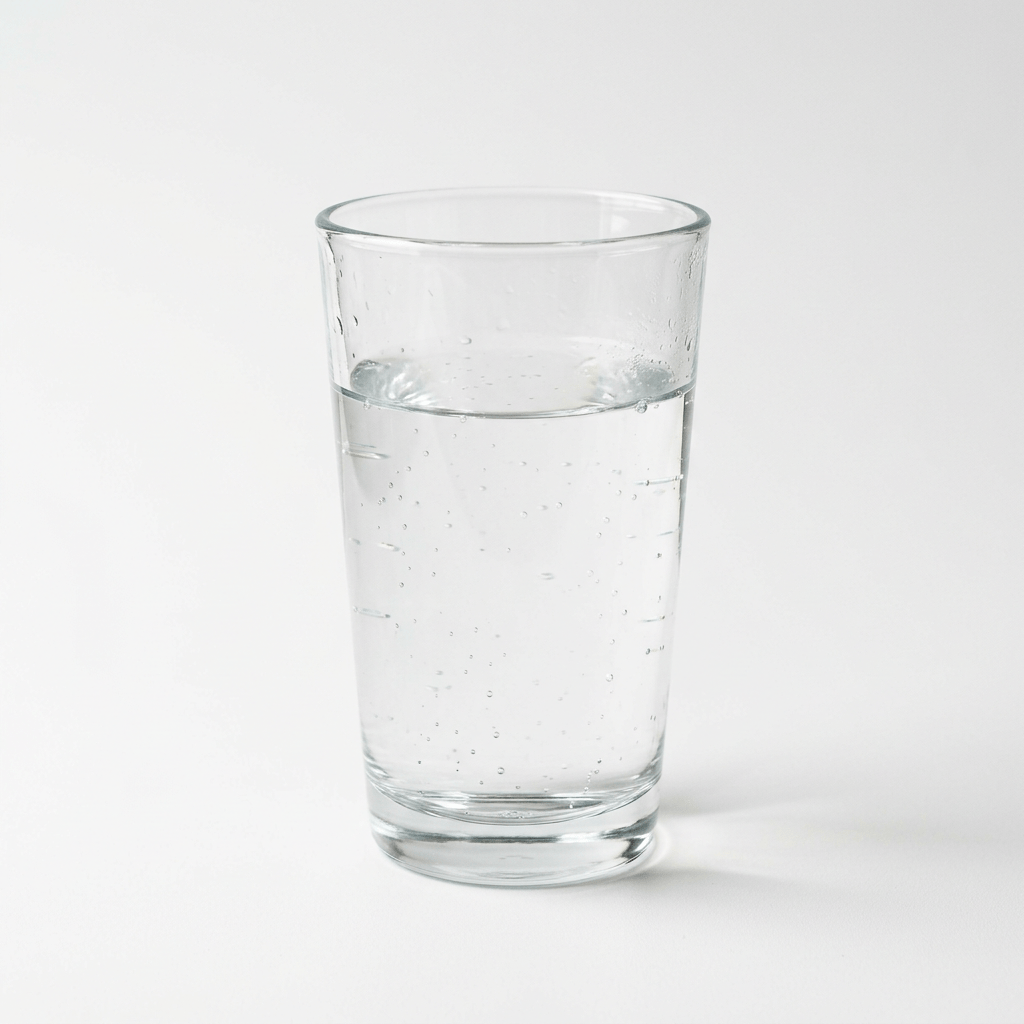 Clear glass filled with sparkling water and bubbles
